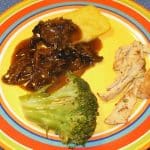 Slow Cooker Polenta with Mushroom Sauce, shown with broccoli and sautéed vegetarian chicken strips.