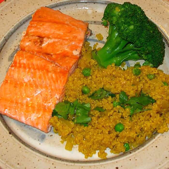Curried Quinoa, shown with salmon and broccoli.