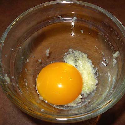 Step 2: Add the egg yolk. Whisk until smooth.