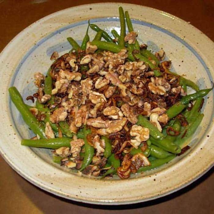 Green Beans, Walnuts and Shallot Crisps side dish has a simple vinaigrette on it.