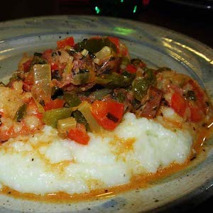 Shrimp and Grits with Sausage over Cheesy Grits. Yum!
