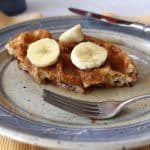 Homemade Basic Waffles (Wheat) are delicious with a bit of syrup and sliced fruit.