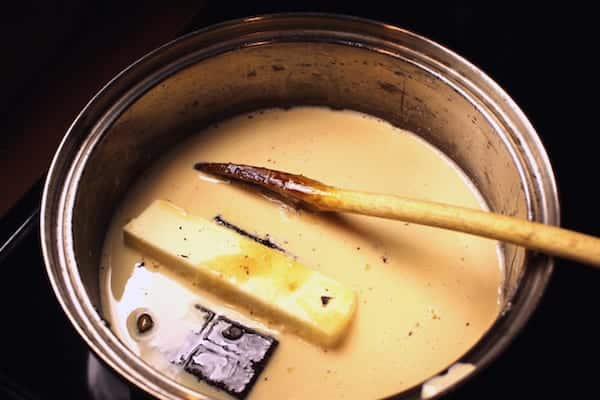 Add all the ingredients except vanilla to a 2-quart, heavy bottomed pan and heat over medium high heat to boiling.