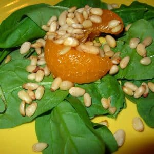 Baby spinach topped by Mandarin oranges and toasted pine nuts.