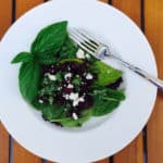 Roasted Beet Salad, topped with feta cheese and served over a bed of spinach.