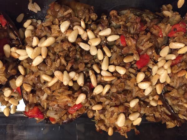Lentil Rice Stuffed Eggplant topped with Pine Nuts