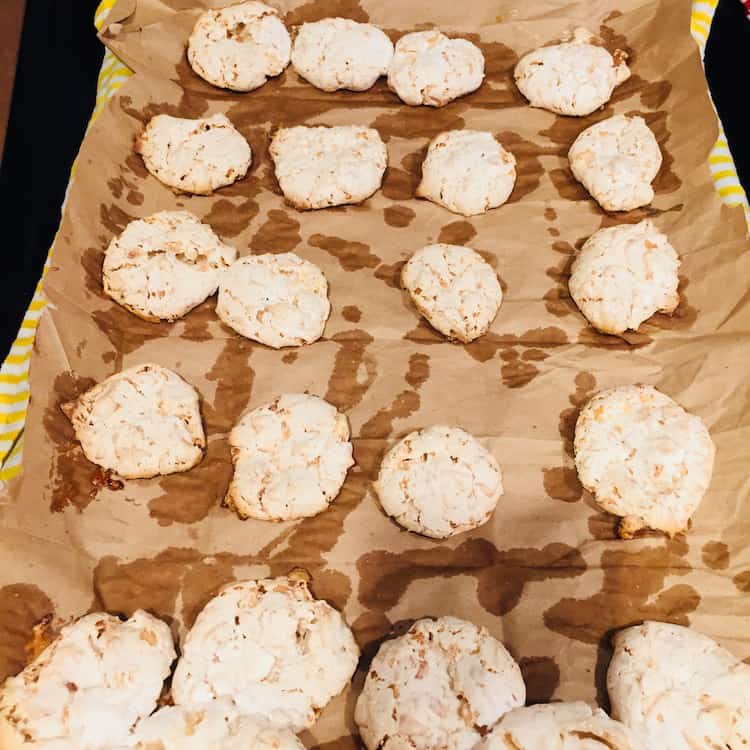 See how the moisture comes through? Coconut Kiss Cookies baked on brown paper and then placed over a wet towel make it easy to remove them.