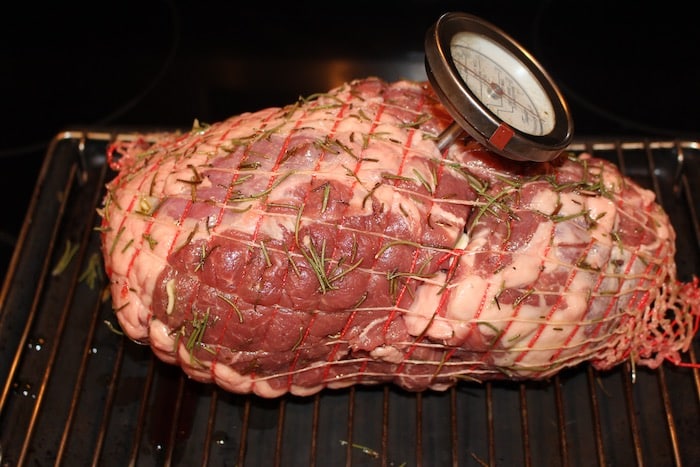 A boneless leg of lamb comes wrapped in a net.