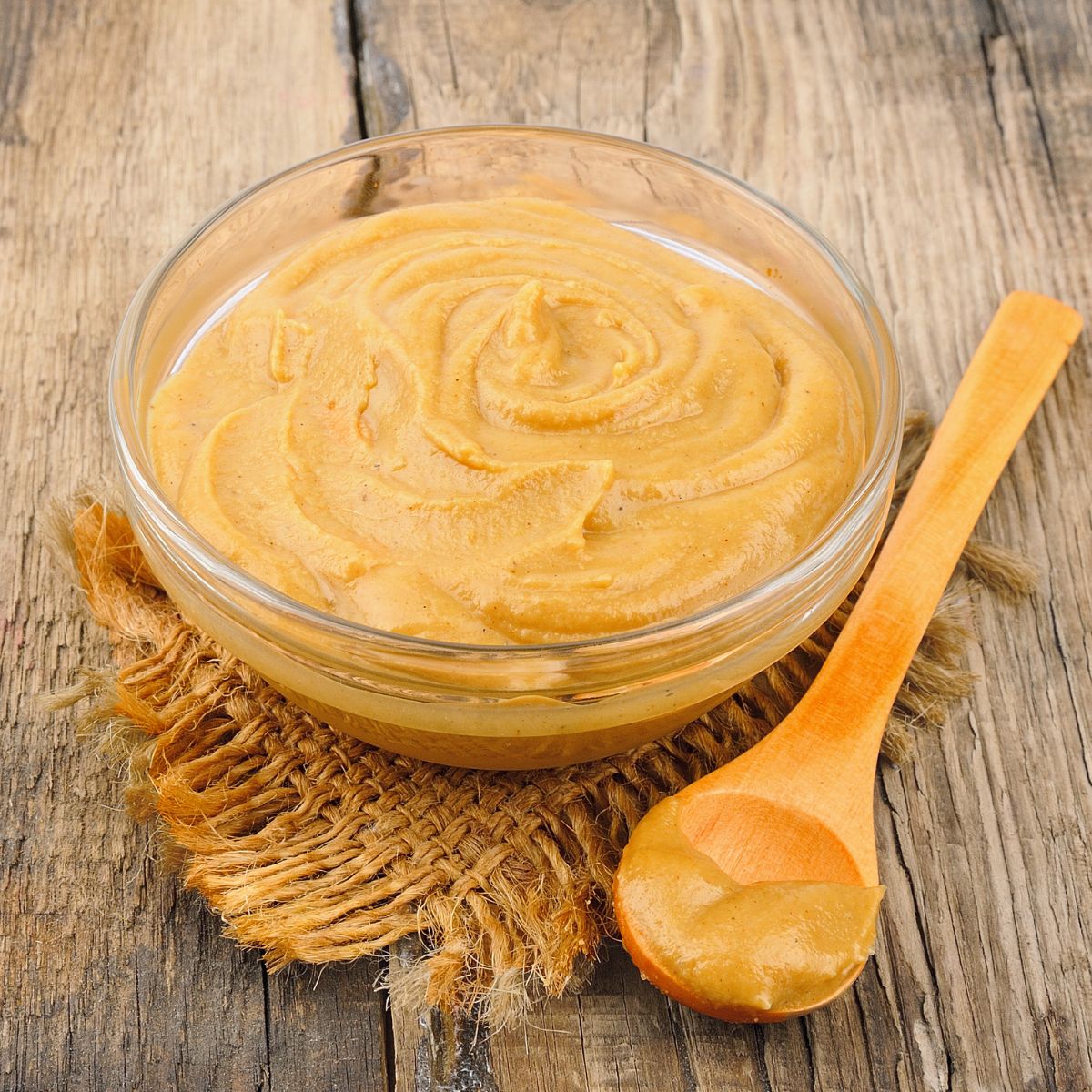 a glass bowl filled with hot mustard sauce. 