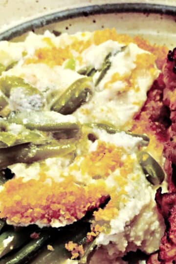 fancy green bean casserole with Swiss cheese, sour cream, and cornflake crums