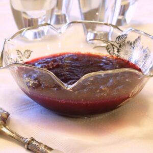 Homemade Jellied Cranberry Sauce made from whole, fresh cranberries, and displayed in a beautiful crystal bowl