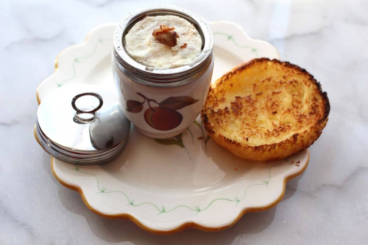 coddled eggs and toasted bread on a white plate