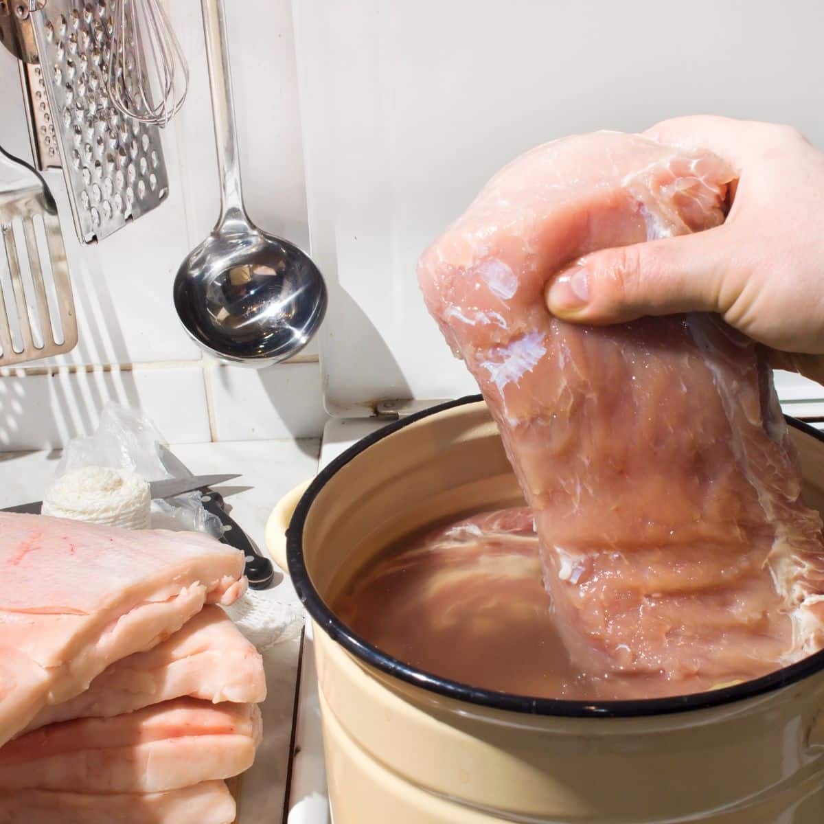 putting meat in pickle brine to tenderize it