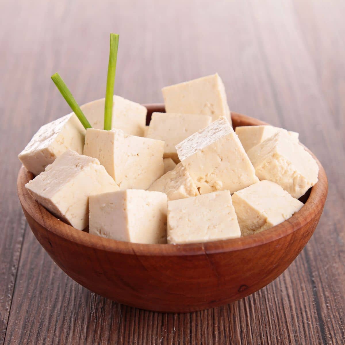 tofu cubes in a wooden bowl