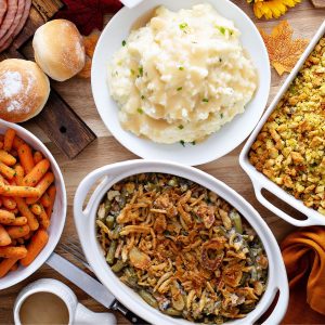Vegan thanksgiving meal: mashed potatoes, cooked carrots, and green bean casserole