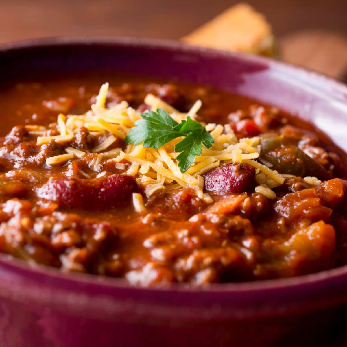 a bowl of chili topped with shredded cheese