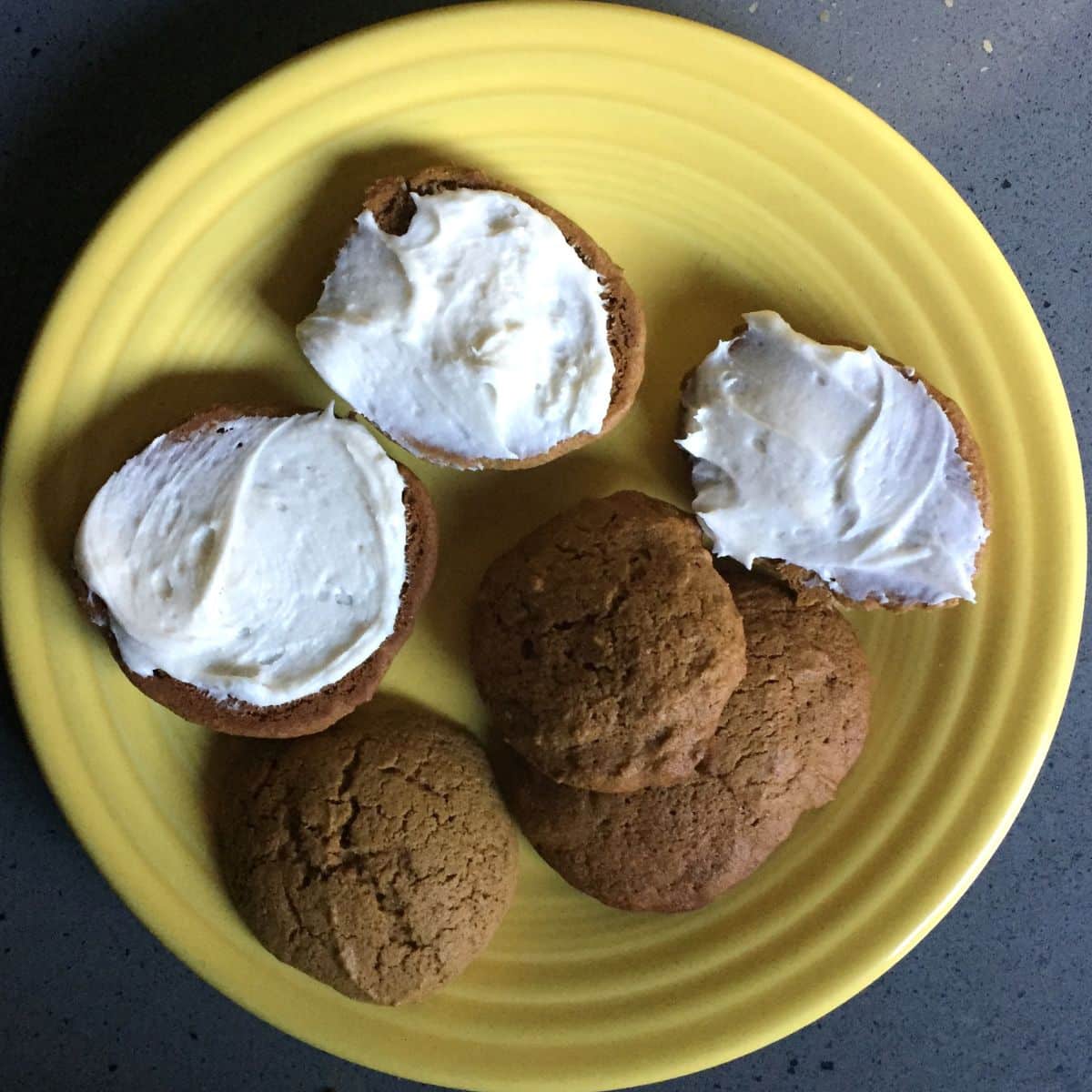 soft ginger molasses cookies on a yellow plate