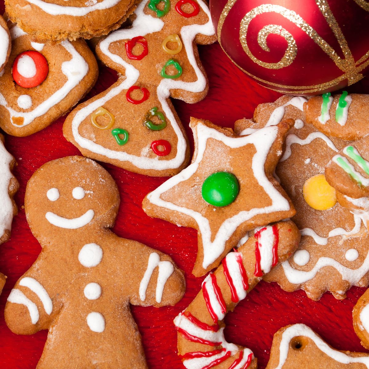 Gingerbread cookies decorated for Christmas with white frosting and colorful M&M's. 