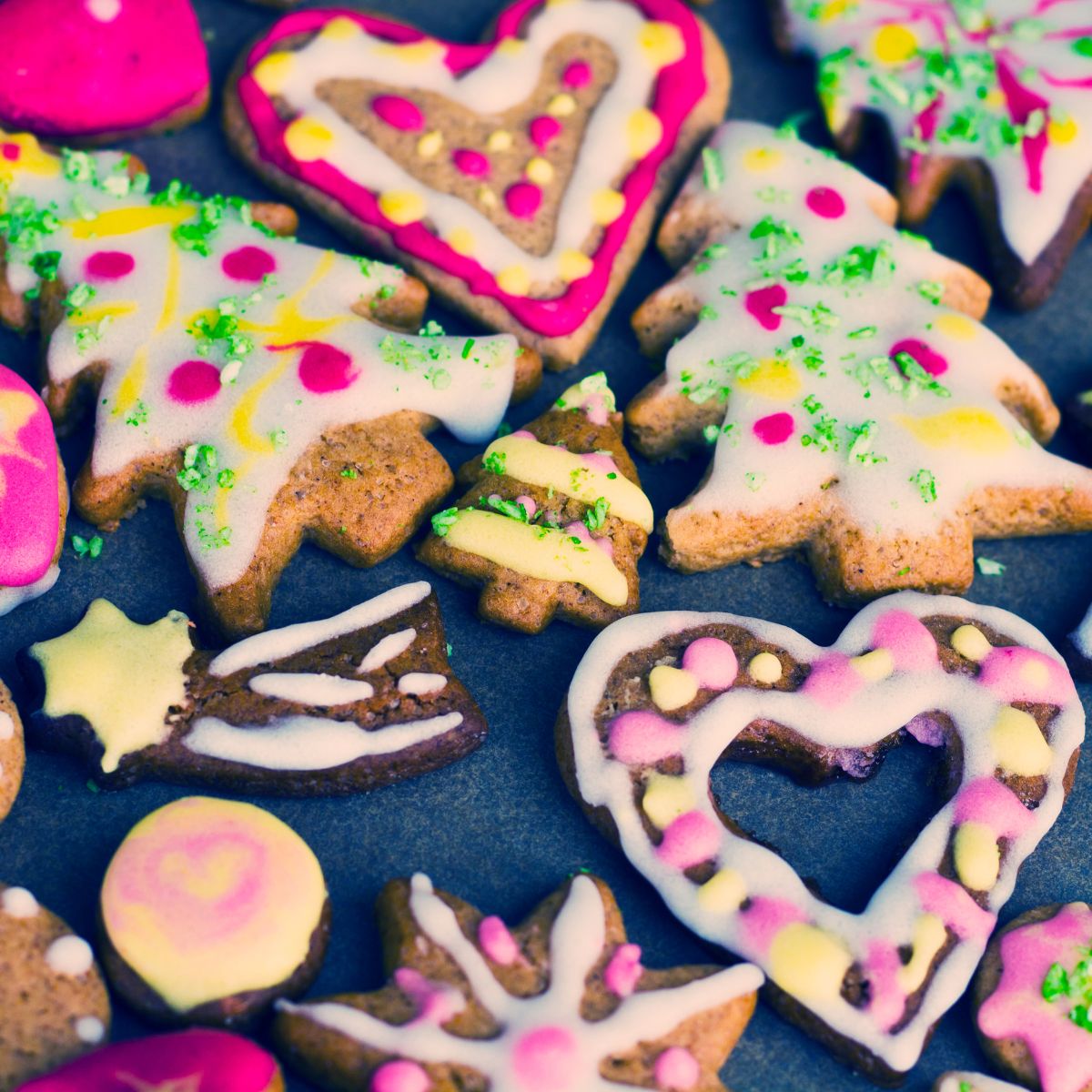 Tree and heart shaped cookies decorated in pastel colors.
