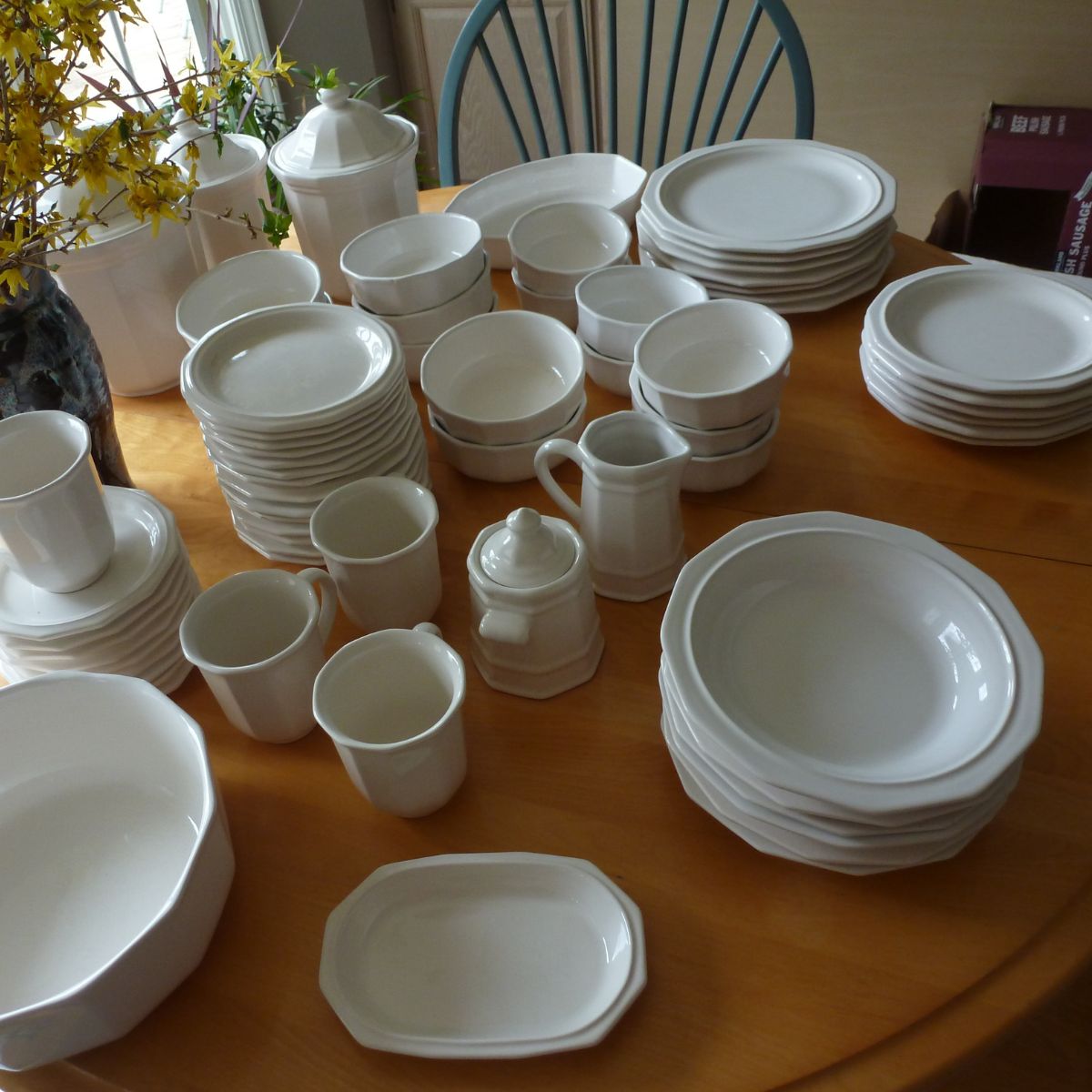 Several Pfaltzgraff heritage pattern dinnerware on a wooden table.