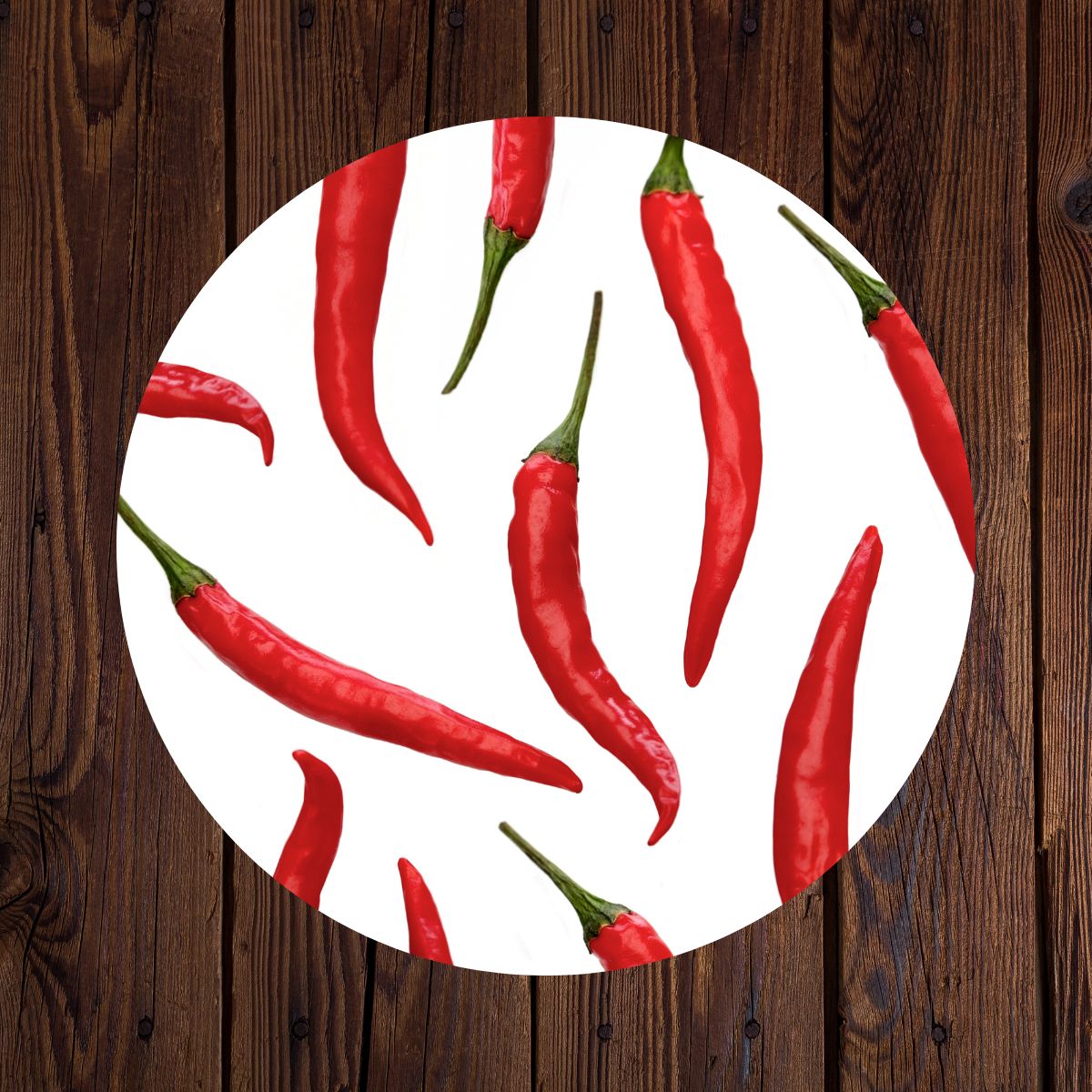 A chili pepper plate sitting on a wooden table.