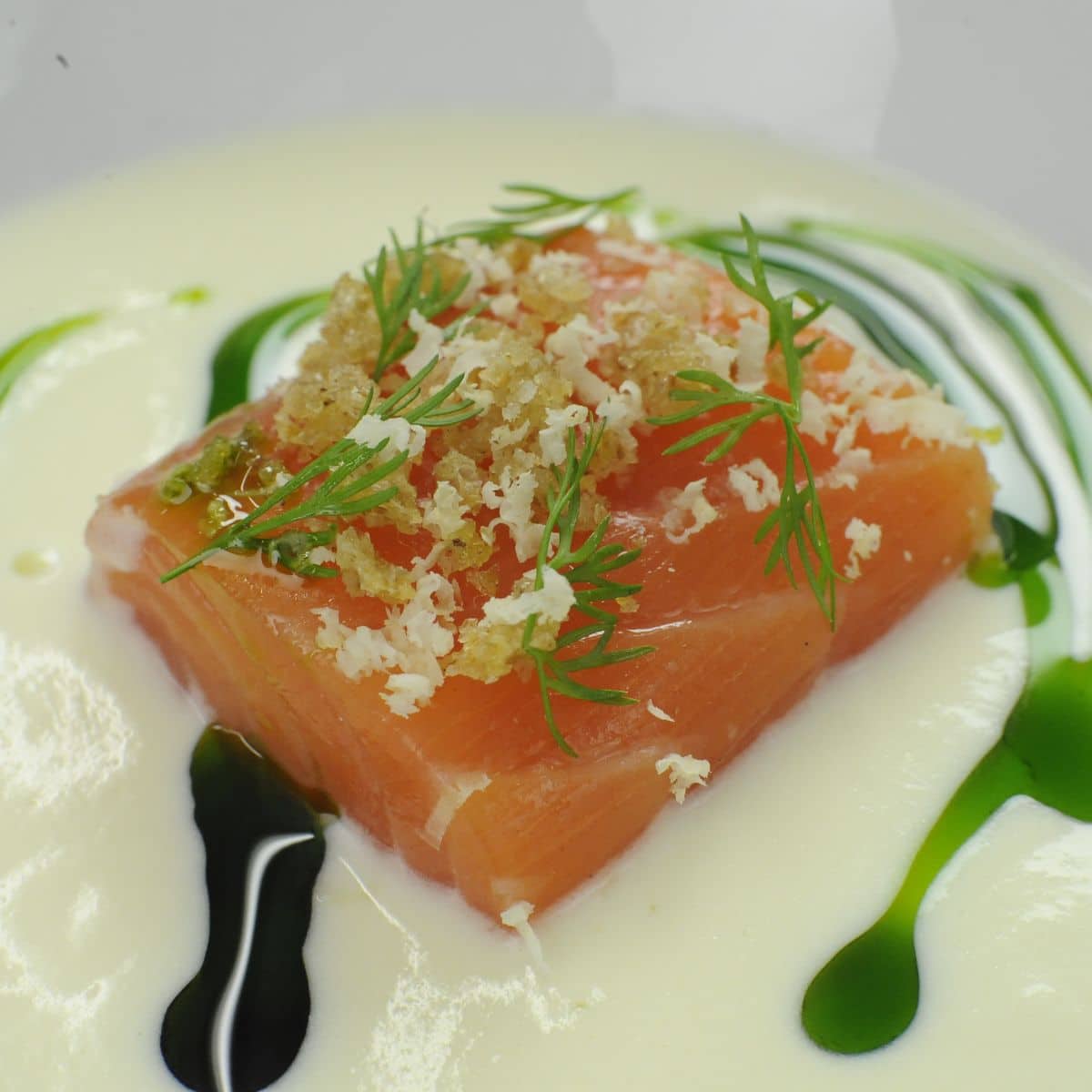 a square piece of salmon topped with minced horseradish, garlic and dill.