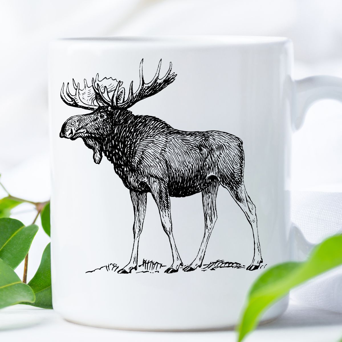 A white mug with a moose pencil drawing on it. 