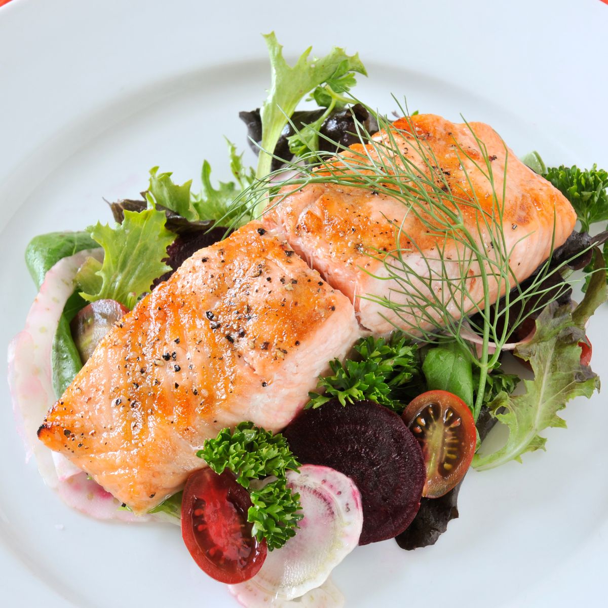 Baked salmon on a bed of salad.