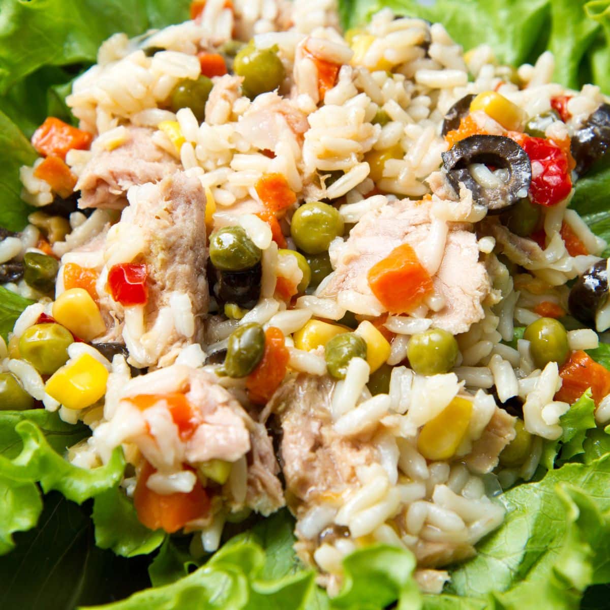 Colorful tuna rice salad on a lettuce leaf.