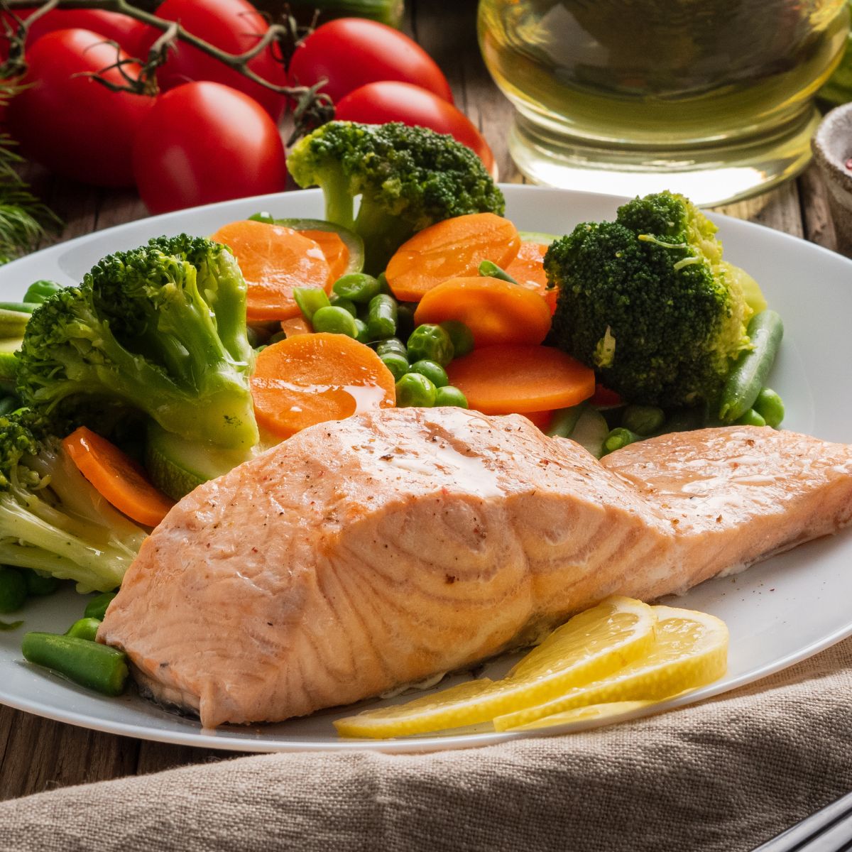 A plate of vegetables and salmon.