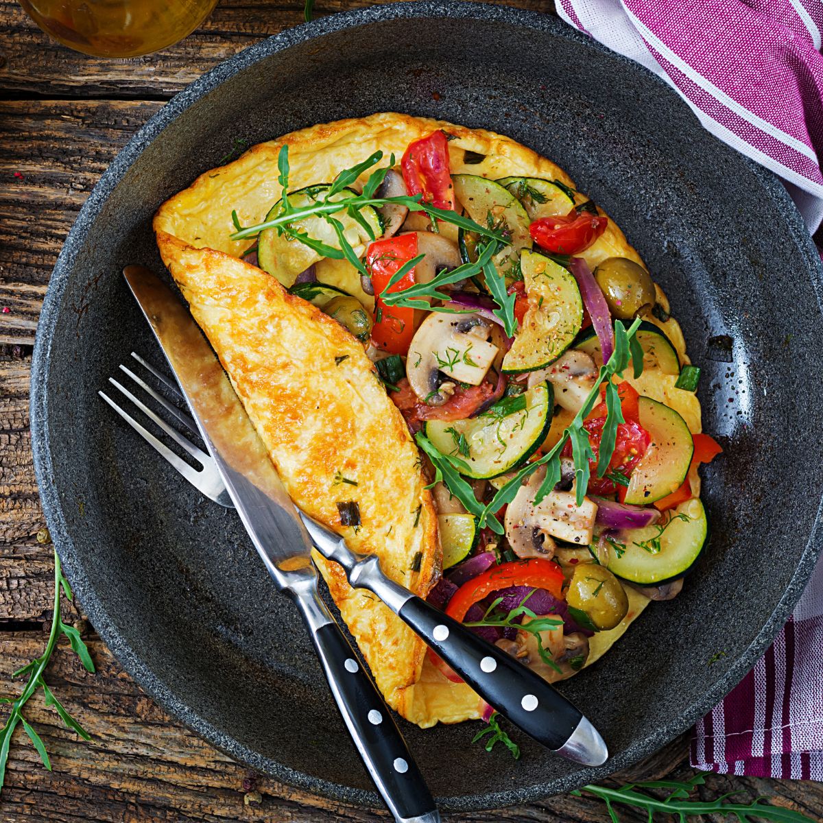 a healthy omelet with lots of colorful veggies.