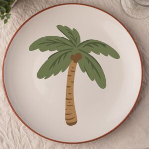 a tan colored plate with a palm tree design.