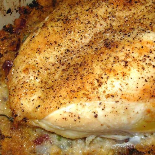 Baked chicken breast over stuffing.
