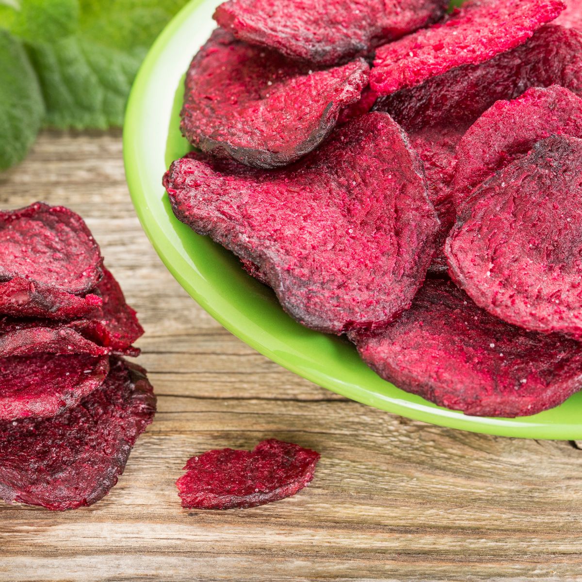 beet chips in a bright green plastic bowl.