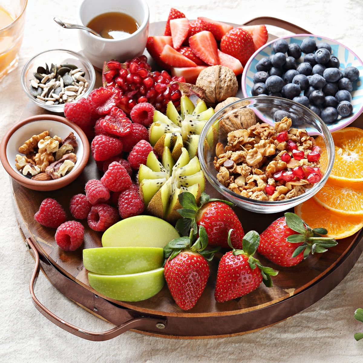 a platter filled with fruits and nuts.