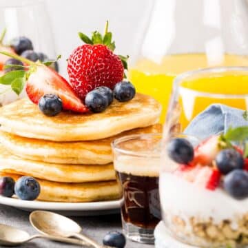 healthy breakfast made of pancakes, berries and Greek yogurt with granola.