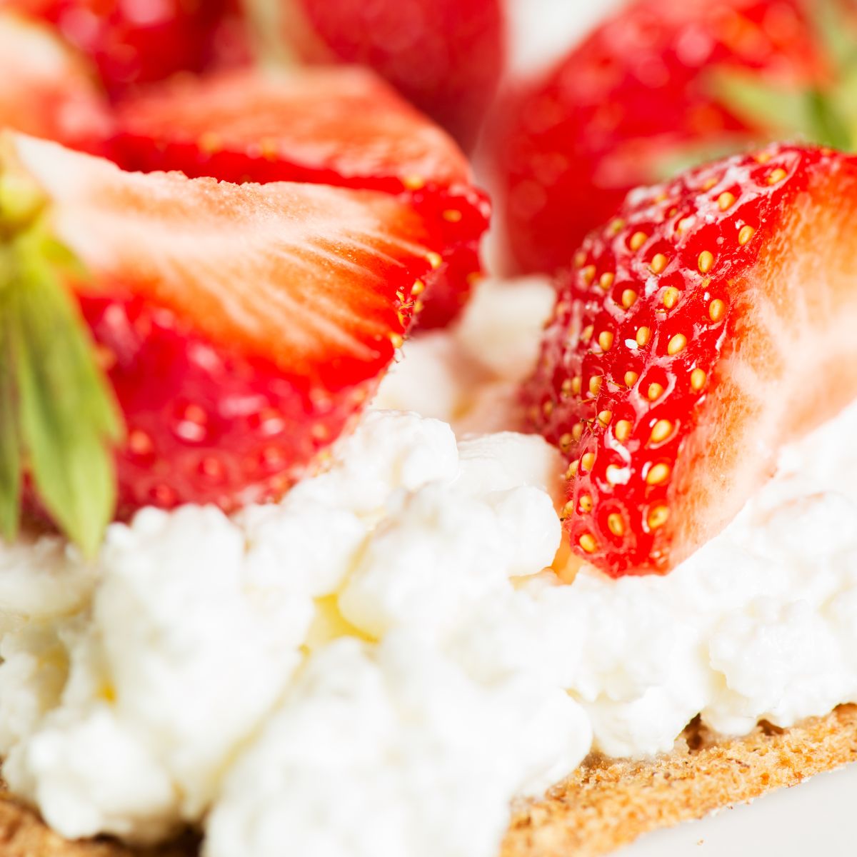 Ricotta with strawberries on a cracker. 