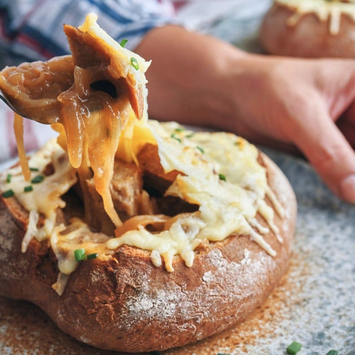 eating French Onion Soup out of a bread bowl