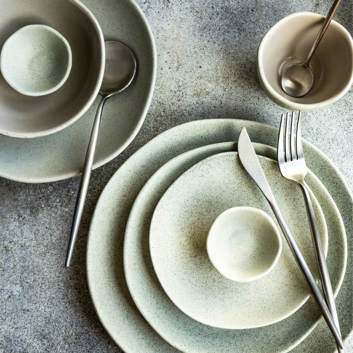 A rustic dinnerware set on the table. 