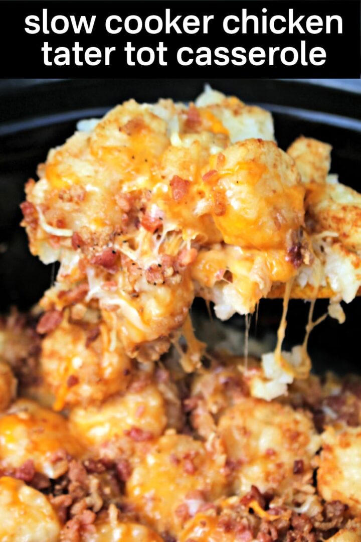 A close-up of Slow Cooker Chicken Tater Tot Casserole, featuring melted cheese, tater tots, crumbled bacon, and shredded chicken, with a hearty serving being lifted fresh from the crockpot.
