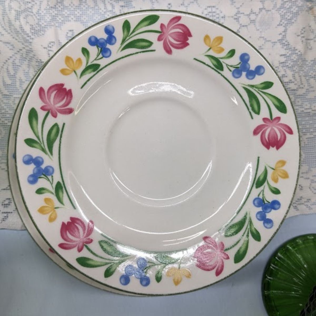 White plates with a colorful flower motif. 