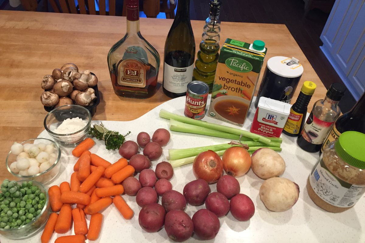 Ingredients for vegan burguignon: peas, carrots, red potatoes, rutabaga, celery, portabela mushroom, and more. 