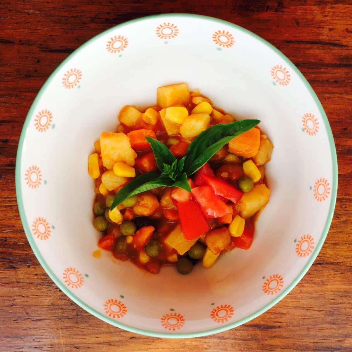 Brightly colored vegetable stew: carrots, red peppers, corn and more.  