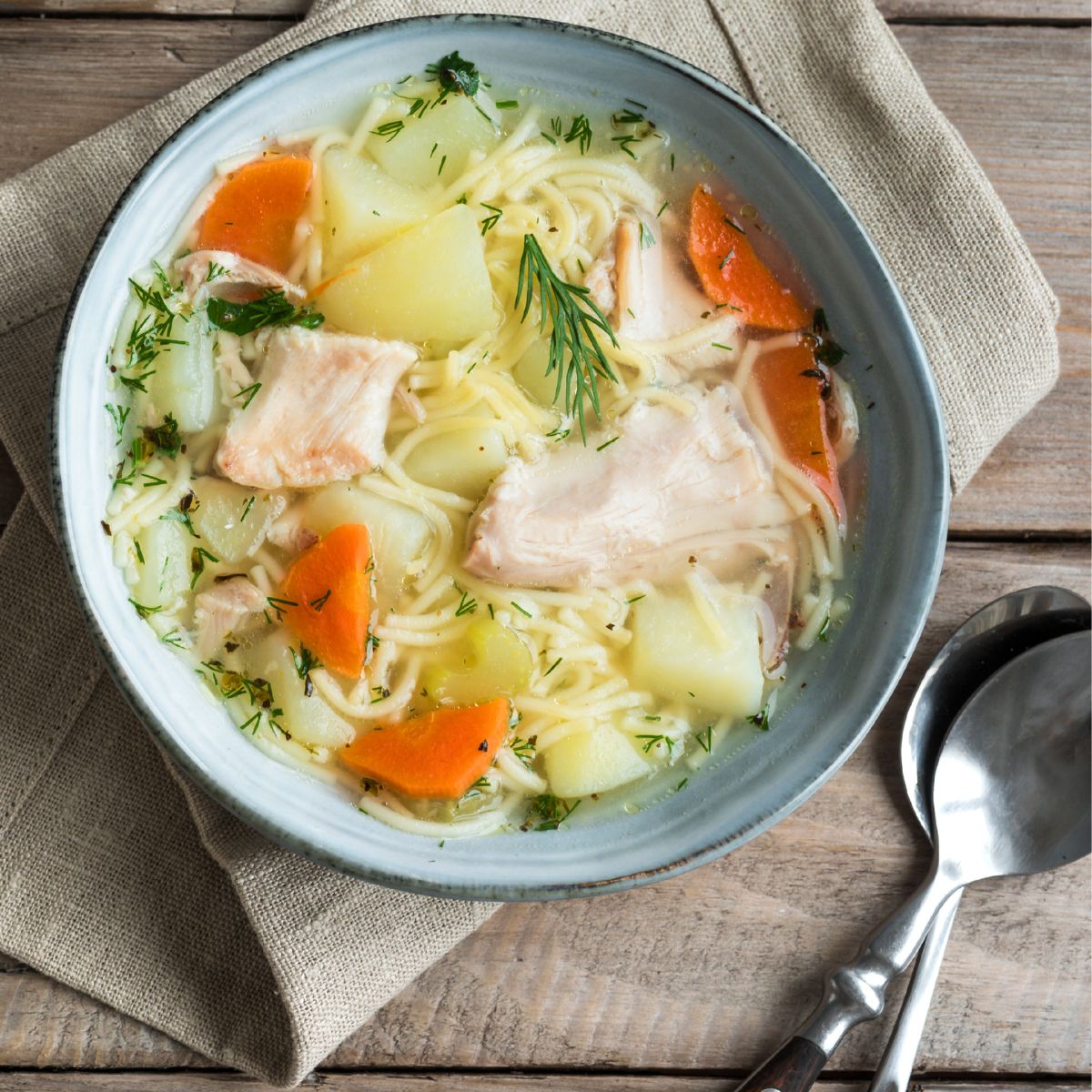 A bowl of delicious looking chicken noodle soup.