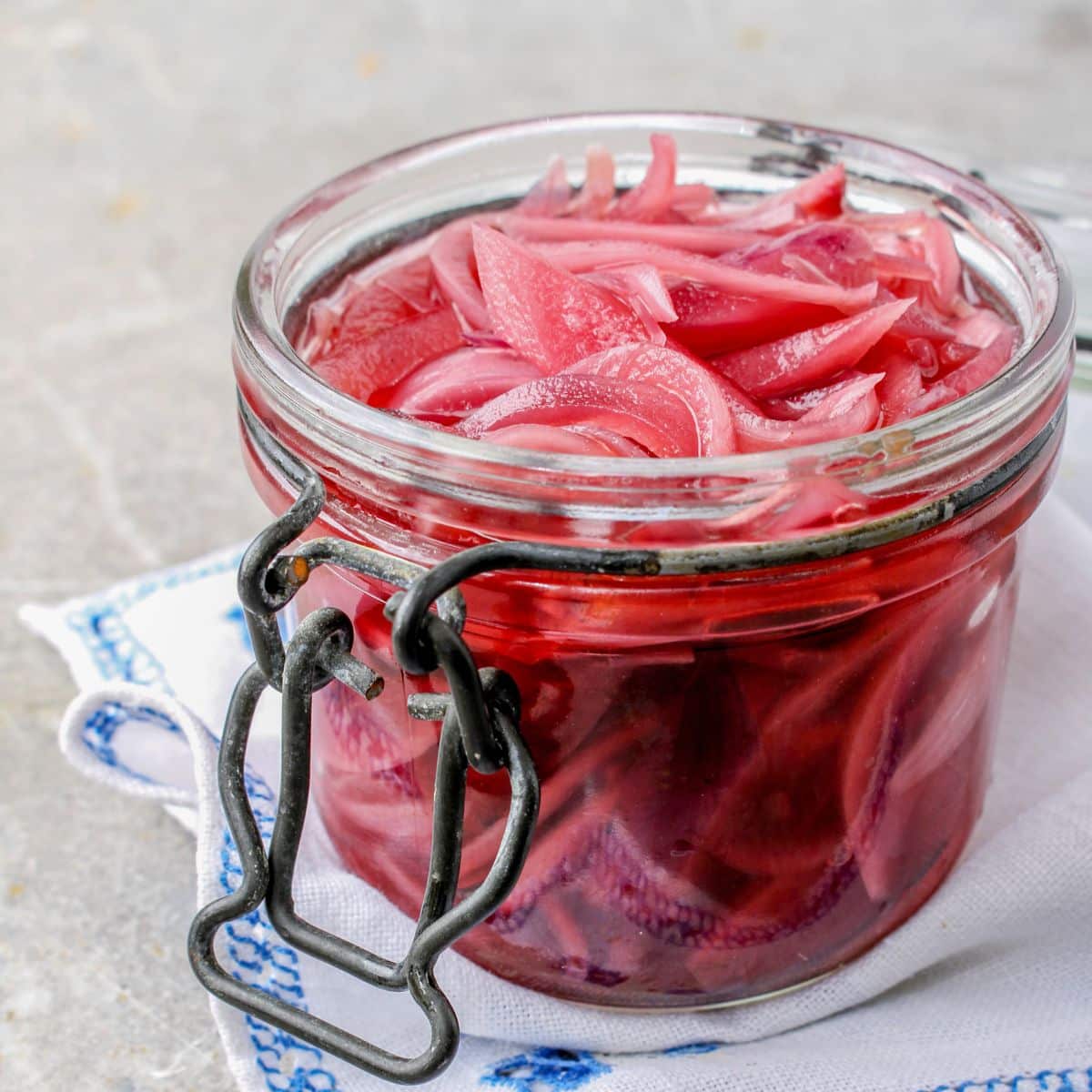 pickled red onions in a glass jar.