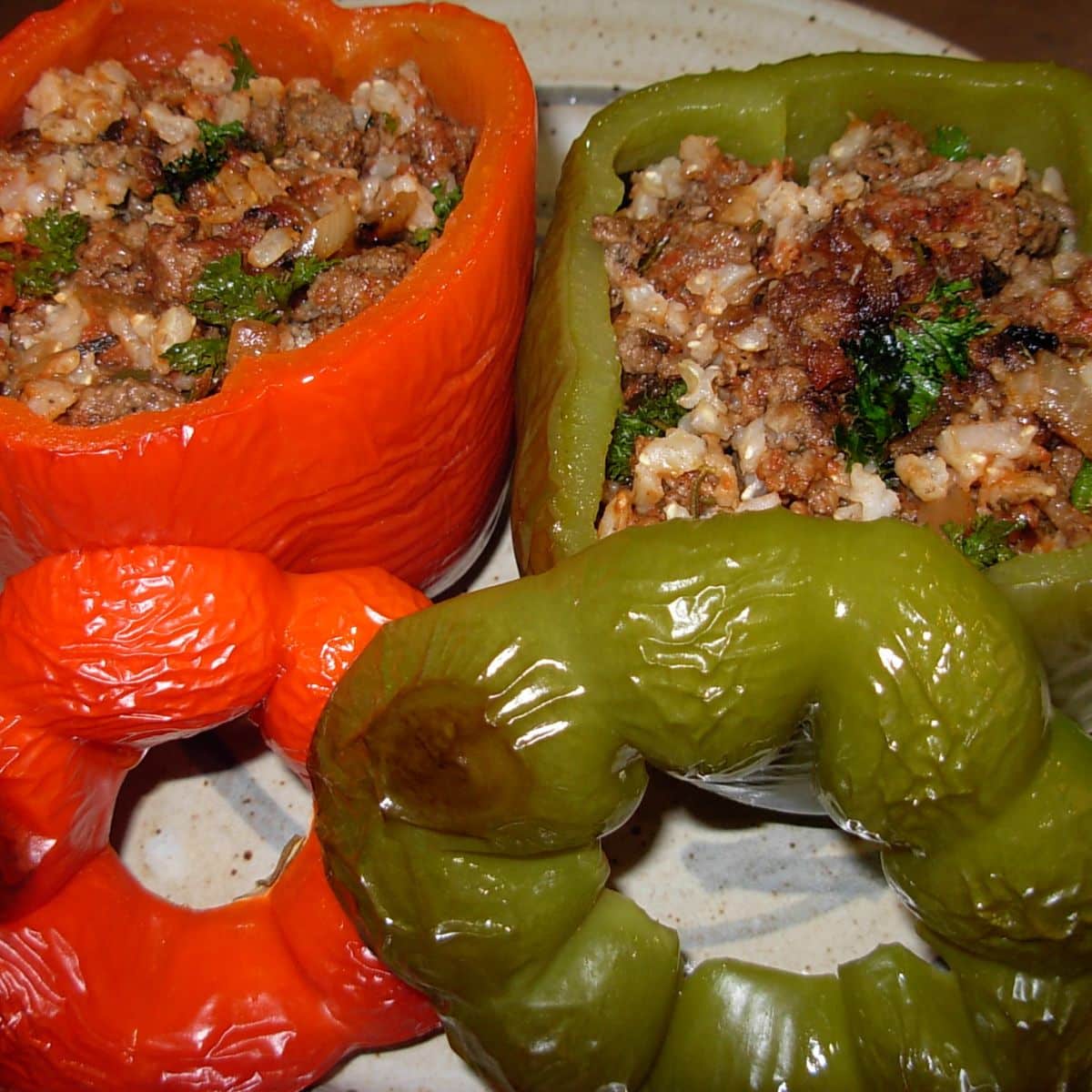 A red and a green pepper, stuffed with a rice mixture. 