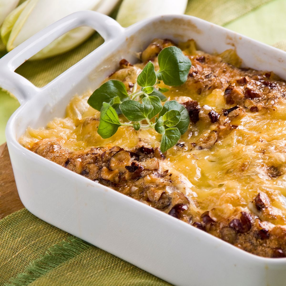 Taco casserole with a sprig of basil. 