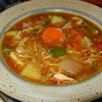 a bowl of mulligatawny soup made with with chicken.