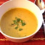 A bowl of bright orange buttercup squash soup.