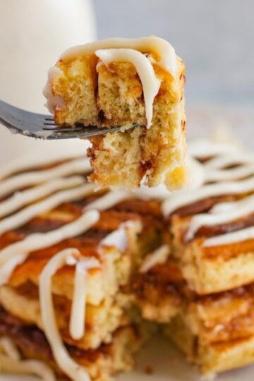 cinnamon roll pancakes with a cream cheese icing drizzle